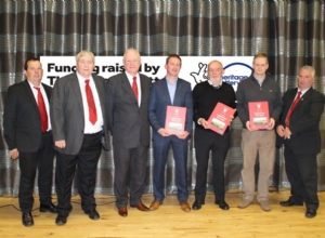 Loughgiel GAC Committee members with Owen Elliott, John Curly McIlwaine and St Annes PS Principal Henry Duffin